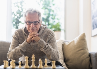 Man looking at chess board